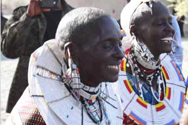 Two Masaai tribe members wearing large beaded necklaces